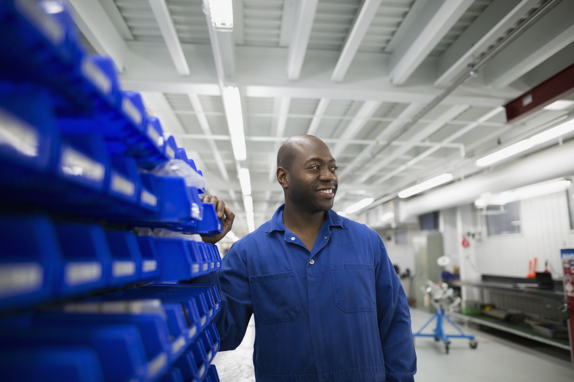 man-smiling-by-bins