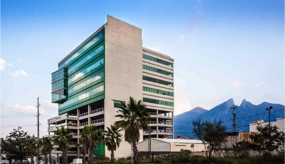 An office building next to palm trees